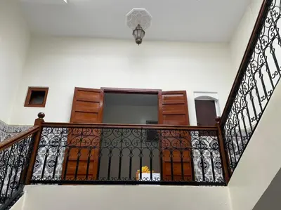 a stairway with a wrought iron railing at Riad Hicham in Marrakech in Marrakech