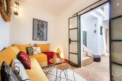 a living room with a couch and a table at Riad Myla - 2mn de Jemaa El Fna in Marrakech