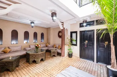 a living room with a couch and a table at Riad Elite in Marrakech
