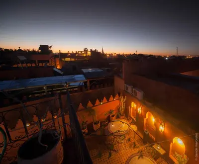 a view from a balcony of a building at night at Riad Bab Tilila in Marrakech