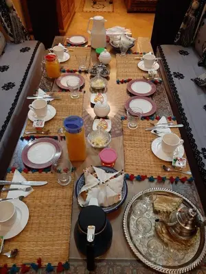 a long table with plates and dishes on it at RIAD Redous in Marrakech