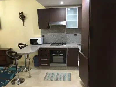 a kitchen with a stove and a counter top at pascal Apartment in Marrakech