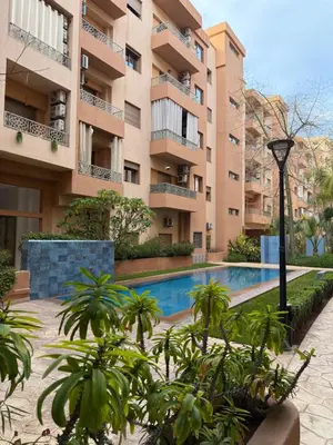 a swimming pool in front of a building at Appartement haut standing in Marrakech