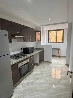 a kitchen with a stove and a counter top at Appartement haut standing in Marrakech