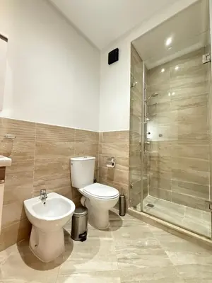 a bathroom with a toilet and a sink and a shower at Appartement haut standing in Marrakech