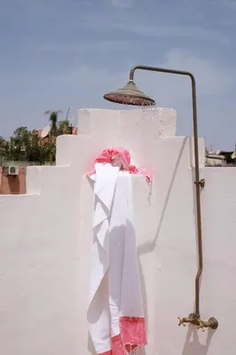 a towel hanging on a wall with a lamp at Riad L'Atelier in Marrakech