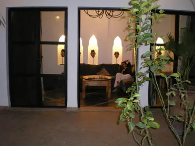 a woman sitting on a couch in a living room at Riad Bab aylen - Piscine Roof Top chauffée in Marrakech