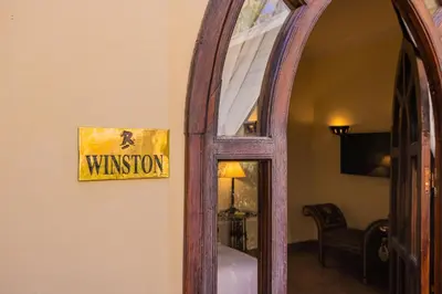 a mirror in a room with a sign on a wall at Riad Il Parco dei Principi in Marrakech