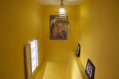 a yellow hallway with a chandelier in a house at Hannah House Marrakech in Marrakech
