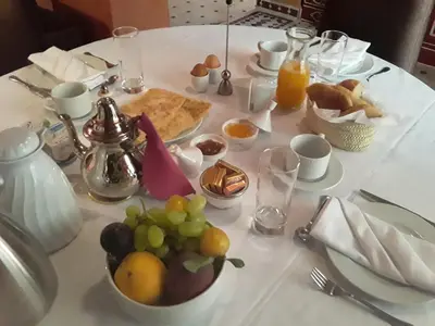 a white table with a bunch of fruit on it at Riad AZARO in Marrakech