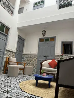 a living room with chairs and a coffee table at RIAD DAR LFONOUN in Marrakech