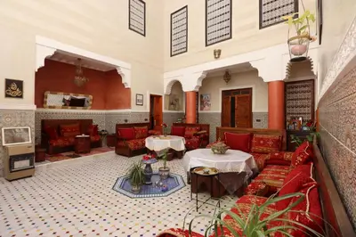 a lobby with couches and tables in a building at Riad Dwiriyat My Teib in Marrakech
