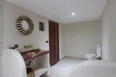a bathroom with a sink and a toilet and a mirror at Riad Dwiriyat My Teib in Marrakech