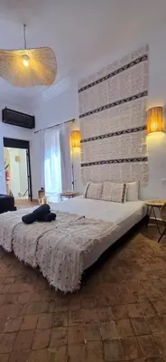 a large bed in a room with a large wall at Riad Kadi in Marrakech