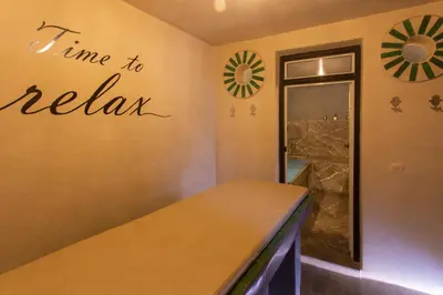 a room with a sign that says time to relax on the wall at Riad Kadi in Marrakech