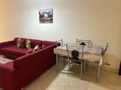 a living room with a red couch and a table at Appartement 33 in Marrakech