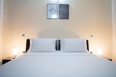 a bedroom with a large white bed with two lamps at Apartment in Marrakesh, Gueliz in Marrakech