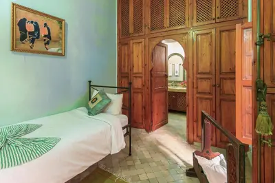 a bedroom with a bed in a room at Riad Couleurs du Sud in Marrakech