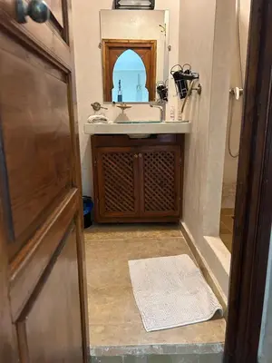 a bathroom with a sink and a mirror at Riad Couleurs du Sud in Marrakech
