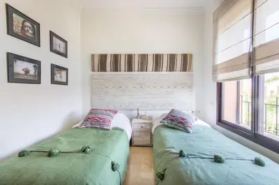 two beds sitting next to each other in a bedroom at Villa Cosy - Jardin de l'Atlas - Golf & Waky in Marrakech