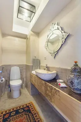 a bathroom with a sink and a toilet and a mirror at Villa Cosy - Jardin de l'Atlas - Golf & Waky in Marrakech