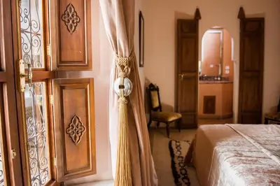 a bedroom with a bed and an open door at Riad Zamzam & Spa in Marrakech