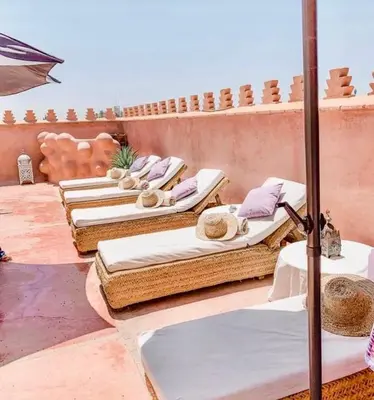 a row of beds sitting on a patio at Riad Zamzam & Spa in Marrakech