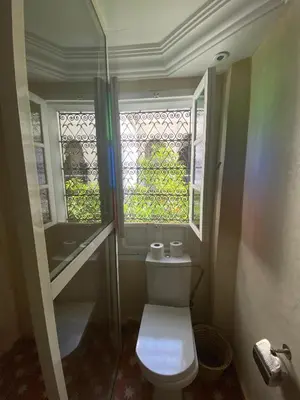a small bathroom with a toilet and a window at Riad Milouda in Marrakech
