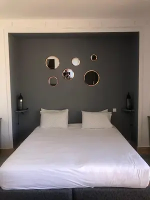 a bedroom with a large white bed with mirrors on the wall at Oasis Jena Marrakech in Marrakech