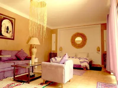 a living room with a bed and a couch at Oasis Jena Marrakech in Marrakech