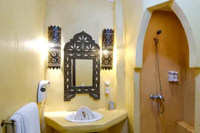 a bathroom with a sink and a mirror at Riad Basma Marrakech in Marrakech
