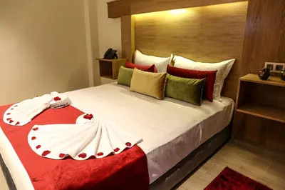 a bedroom with a large bed with red pillows at LE VOYAGEUR MARRAKECH in Marrakech