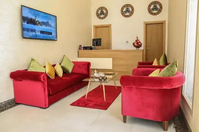 a living room with two red chairs and a table at LE VOYAGEUR MARRAKECH in Marrakech
