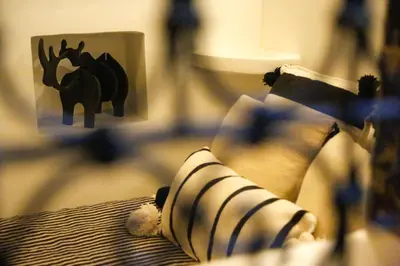a stuffed animal on a bed with a picture of an elephant at Riad Dada Mouss & Suites in Marrakech