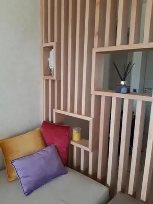 a room with a couch with three pillows on it at Jade Golf City in Marrakech