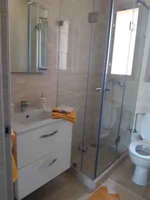 a bathroom with a shower and a sink and a toilet at Jade Golf City in Marrakech