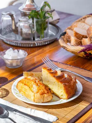 a table topped with a plate of bread and pastries at Riad Come & Va Medina in Marrakech