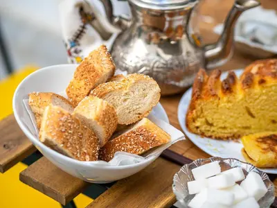 a bowl of bread and a plate of bread at Riad Come & Va Medina in Marrakech