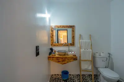 a bathroom with a sink and a mirror and a toilet at Riad des remparts Marrakech in Marrakech
