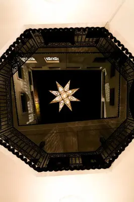 a mirror with a star on a wall at La Voûte Étoilée in Marrakech