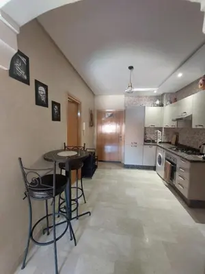 a kitchen with a table and chairs in a room at Marrakesh home in Marrakech