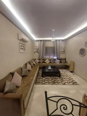 a living room with a long couch and a table at Marrakesh home in Marrakech