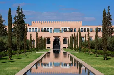 a building with a pond in front of it at The Oberoi Marrakech in Marrakech