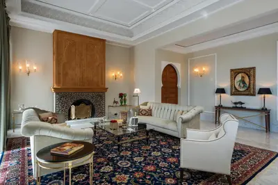 a living room with two couches and a fireplace at The Oberoi Marrakech in Marrakech