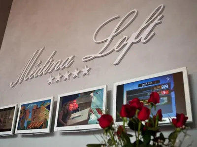 a sign for a video game store with red roses at Medina Loft & Spa in Marrakech