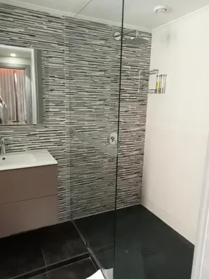 a bathroom with a glass shower with a person in it at Medina Loft & Spa in Marrakech