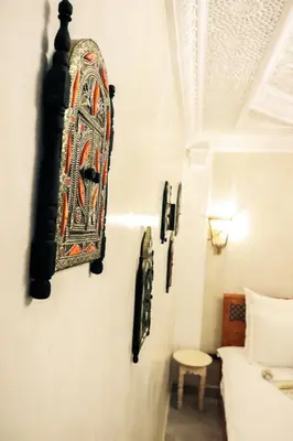 a room with a bed and a painting on the wall at Riad azra Marrakech in Marrakech