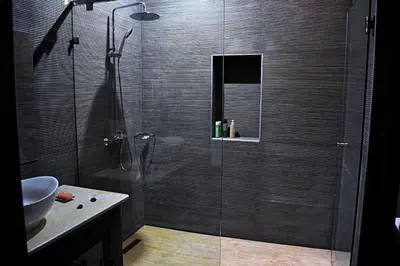 a shower with a glass door in a bathroom at Riad Dar DARRE in Marrakech