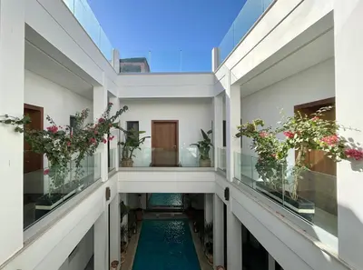 an internal corridor of a house with a pool at Riad Dar DARRE in Marrakech