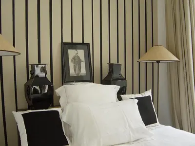 a bedroom with a bed with white sheets and two lamps at Dar Seven in Marrakech